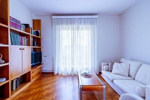 a living room with a white couch and a table at Home La Quiete. Two Bedrooms, 250m from the Beach in Ospedaletti