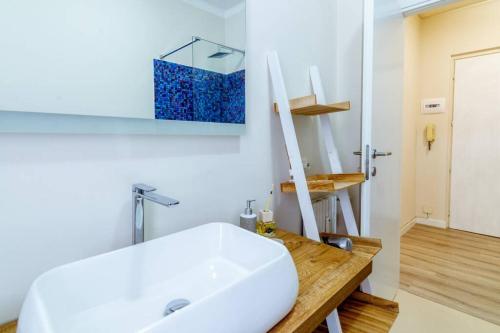 a bathroom with a white sink and a mirror at Home La Quiete. Two Bedrooms, 250m from the Beach in Ospedaletti