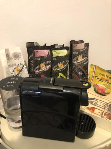 a counter with a coffee maker and packets of food at Casa Barbara in Mantova