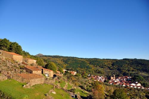 a small village on a hill with a town at Casa Rural Las Jañonas CC-CR-00219 in Gata