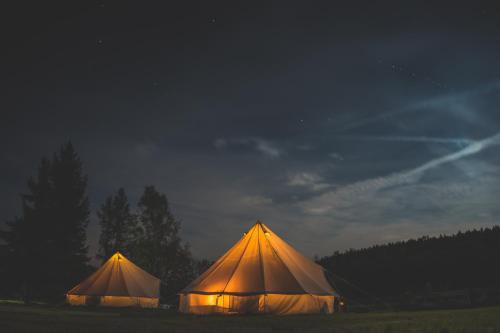 two large tents in a field at night at Trapani house & camp in Růžová