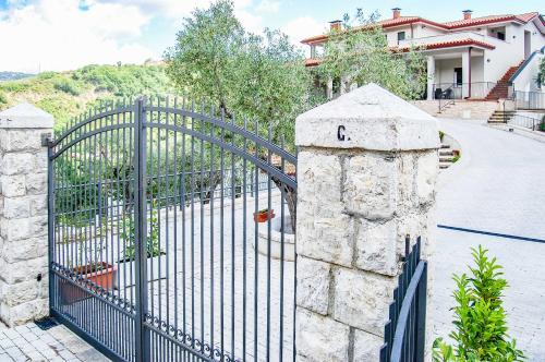a metal gate in front of a house at Casa Elisabetta ShortLets in Caposele