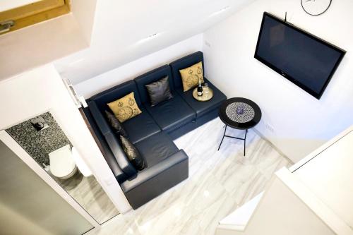 an overhead view of a living room with a couch and a tv at Langery Residence Central Apartments in Odesa