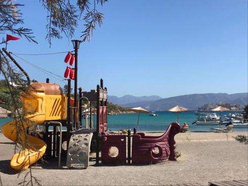 a playground on the beach next to the water at Villa Estée, luxury villa with private infinity pool and jacuzzi in Elounda