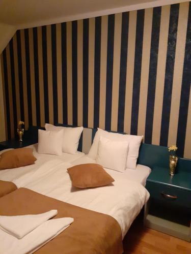 two beds with pillows on them in a room at Casa Leucian in Deva