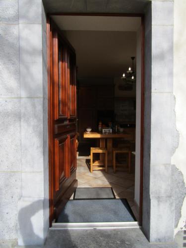 an open door into a room with a table at La Ferme de Sous-Lachat in Samoëns