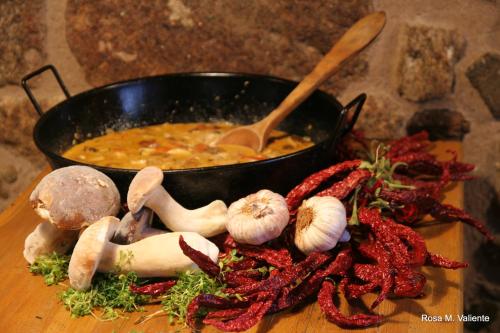 a pot of soup with a bunch of vegetables on a table at Casa Rural Las Jañonas CC-CR-00219 in Gata