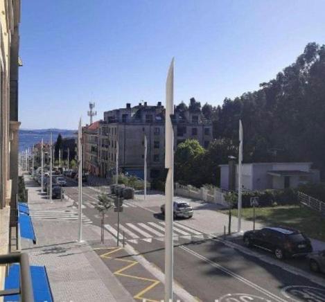 a view of a city with a street with cars at Apartamento con piscina en el centro de Sanxenxo in Sanxenxo