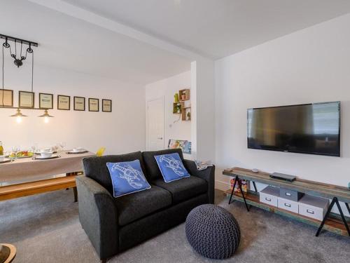 a living room with a couch and a large tv at St James By the Quay in Ilfracombe