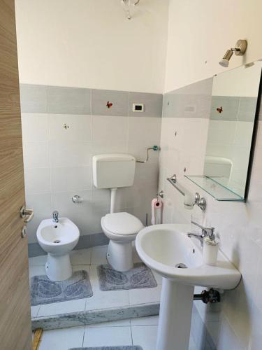 een badkamer met een wit toilet en een wastafel bij Casa Vacanze San Nicolò in Militello in Val di Catania