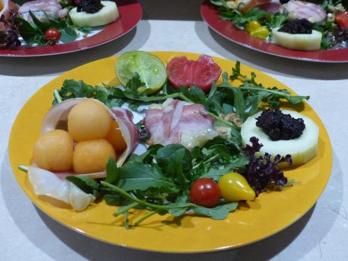 a yellow plate of food on a table at L ' AMIRADOU in Félines-sur-Rimandoule
