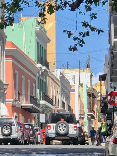 a city street with cars parked on the street at Navona Studios in San Juan