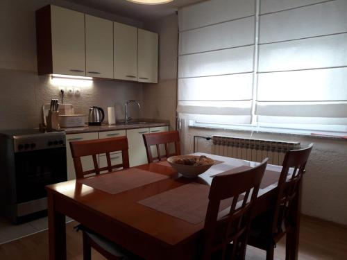 a kitchen with a table with a bowl on it at Apartment Upper Town in Gospić