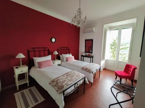 a red bedroom with two beds and a red wall at Casa Borrelli in Casoli