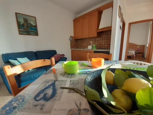 a kitchen with a table with a bowl of fruit on it at Lorena house in Brenzone sul Garda