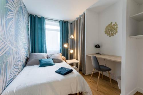 une chambre avec un lit avec des oreillers bleus dessus dans l'établissement Le Romanesque, à Mont-Saint-Aignan