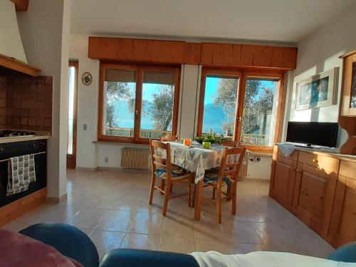 a kitchen with a table and chairs in a room at Lorena house in Brenzone sul Garda
