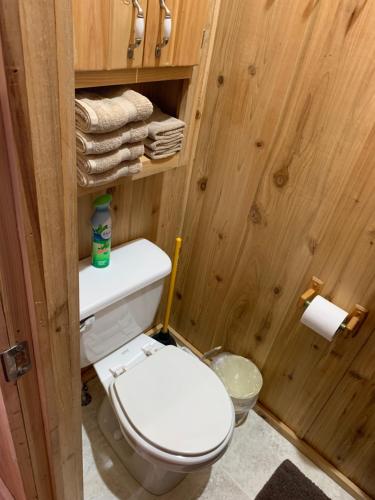 a bathroom with a white toilet in a wooden room at Bearlodge Mountain Resort in Sundance