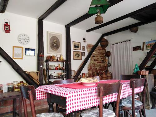 a dining room with a red and white table and chairs at Sobe Gajić in Sremski Karlovci