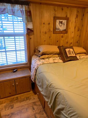 a bedroom with a bed and a window at Bearlodge Mountain Resort in Sundance