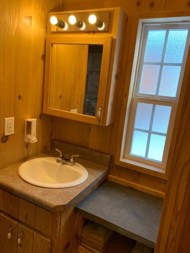 a bathroom with a sink and a window at Bearlodge Mountain Resort in Sundance