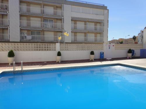 a large swimming pool in front of a building at Bertur Forner in Peniscola