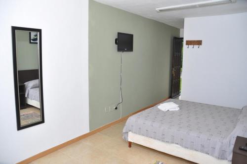 Cama o camas de una habitación en Posada del Barranco Apart & Suites