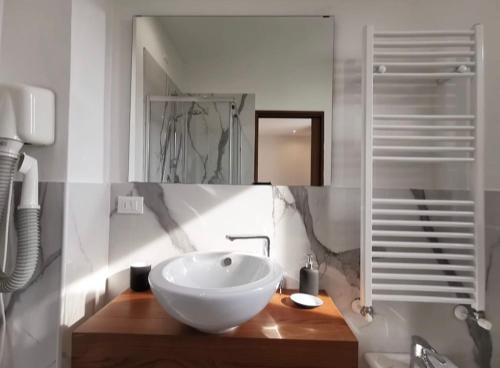 a bathroom with a white bowl sink on a wooden counter at Civico21 in Padova