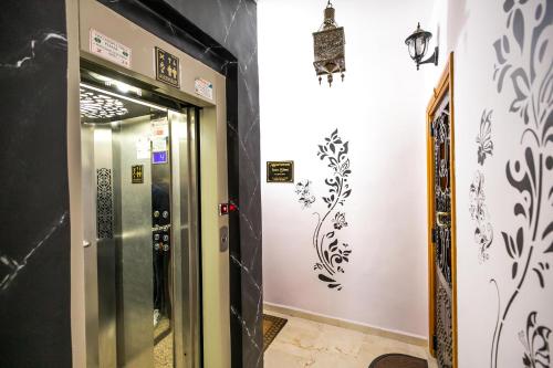 an elevator in a building with a sign on the wall at Appartement Luxe Simo in Fès