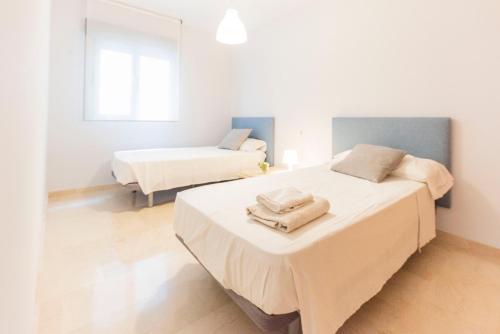 a bedroom with two beds with towels on them at GLP ALTEA DREAMS in Altea