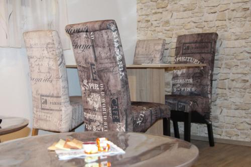 a room with two chairs with writing on them at Ermis Apartments in Metzingen