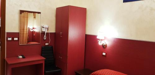a bathroom with red walls and a red cabinet at Vertex Palace in Rome