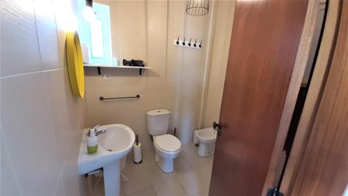 a small bathroom with a toilet and a sink at Tavira Lovers - City Centre Apartment II in Tavira