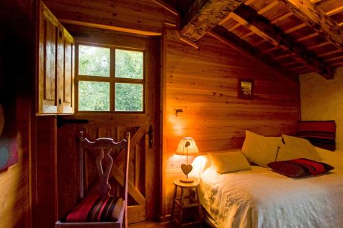 a bedroom with a bed and a window and a lamp at El Casal in Prats-de-Mollo-la-Preste