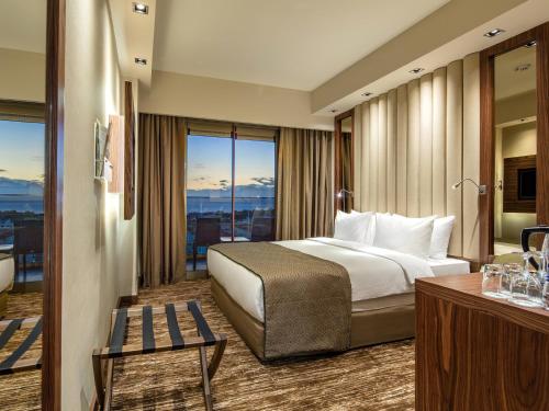 a hotel room with a bed and a view at Holiday Inn Antalya - Lara by IHG in Antalya