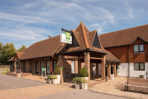 a building with a sign on top of it at Holiday Inn Ashford Central by IHG in Ashford