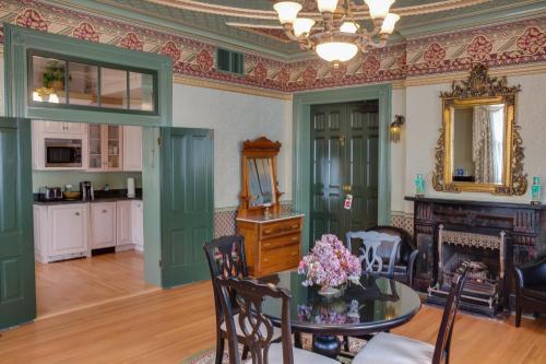 a living room with a table and a fireplace at Beaumont Hotel and Spa - Adults Only in Ouray