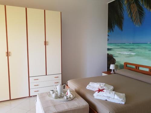 a bedroom with two beds and a view of the ocean at Casa Laura in Acciaroli