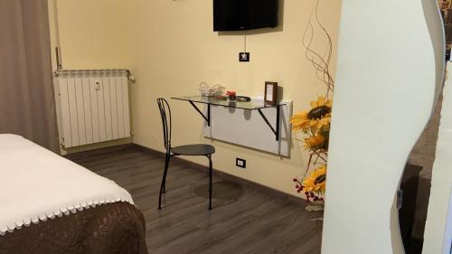 a room with a table and a chair in a room at Sweet Rome B&B in Rome