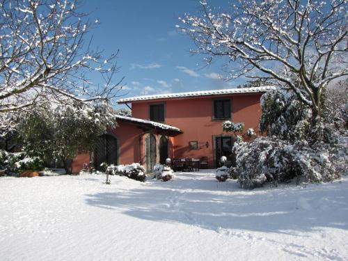 a house with snow on the ground in front of it at B&B Ai Glicini - Castelli Romani in Marino