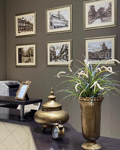 a room with a desk and a vase with a plant at Hotel Banja Luka in Banja Luka
