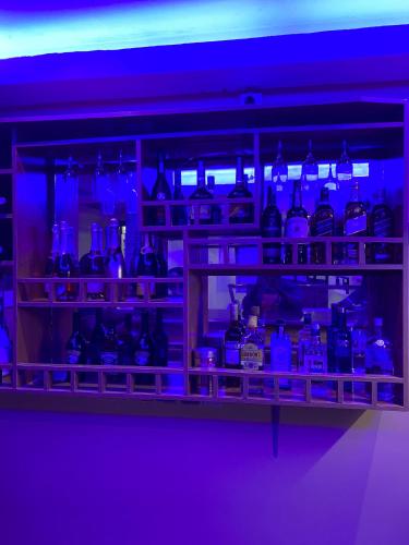 a shelf filled with lots of blue glass bottles at Posh Hotel and Suites Victoria Island in Lagos