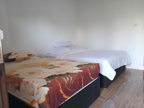 Кровать или кровати в номере Ramdan Homestay