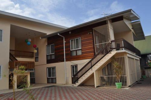 a building with a staircase on the side of it at Amalia Apartments in Paramaribo