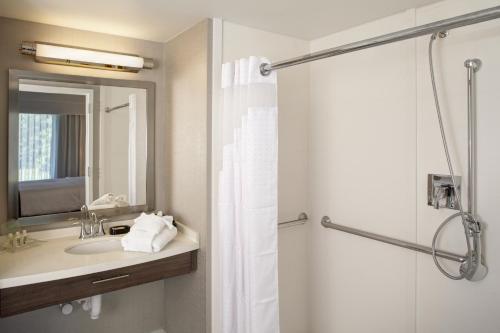 a bathroom with a sink and a shower with a mirror at Holiday Inn Franklin - Cool Springs, an IHG Hotel in Brentwood