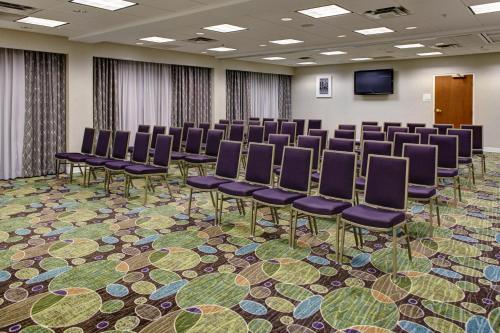 a conference room with chairs and a screen at Holiday Inn Franklin - Cool Springs by IHG in Franklin