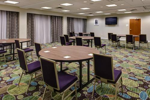 a conference room with tables and chairs and a tv at Holiday Inn Franklin - Cool Springs by IHG in Franklin