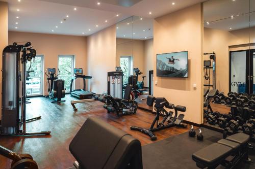 a gym with several treadmills and exercise bikes at Holiday Inn Berlin City Center East Prenzlauer Berg by IHG in Berlin