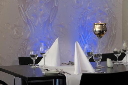 a table with wine glasses and a candle on it at Holiday Inn Berlin City-West by IHG in Berlin