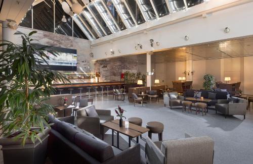 a large lobby with couches and tables and chairs at Holiday Inn Berlin City-West by IHG in Berlin